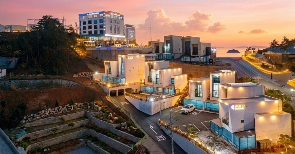 a group of buildings in a city at night at Gaza Spa Pool Villa Yeosu in Yeosu