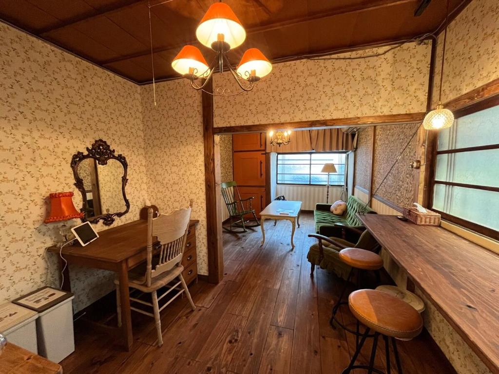 a living room with a wooden table and a desk at 十度-jude- in Osaka
