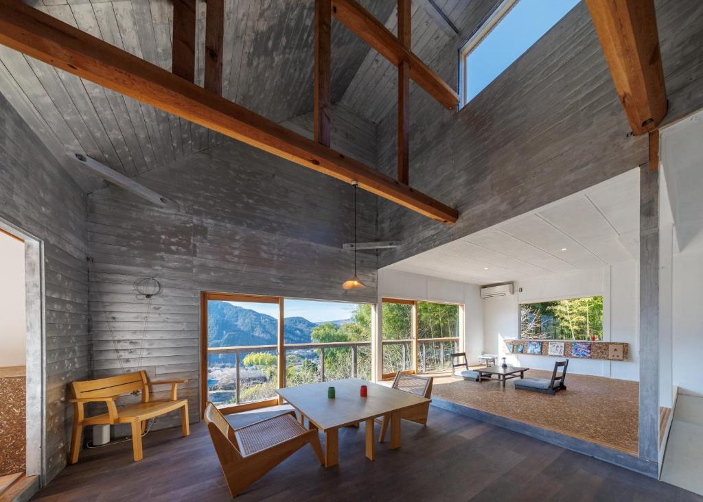 an open living room with a table and chairs at OKANiWA 丘庭 in Nagiso