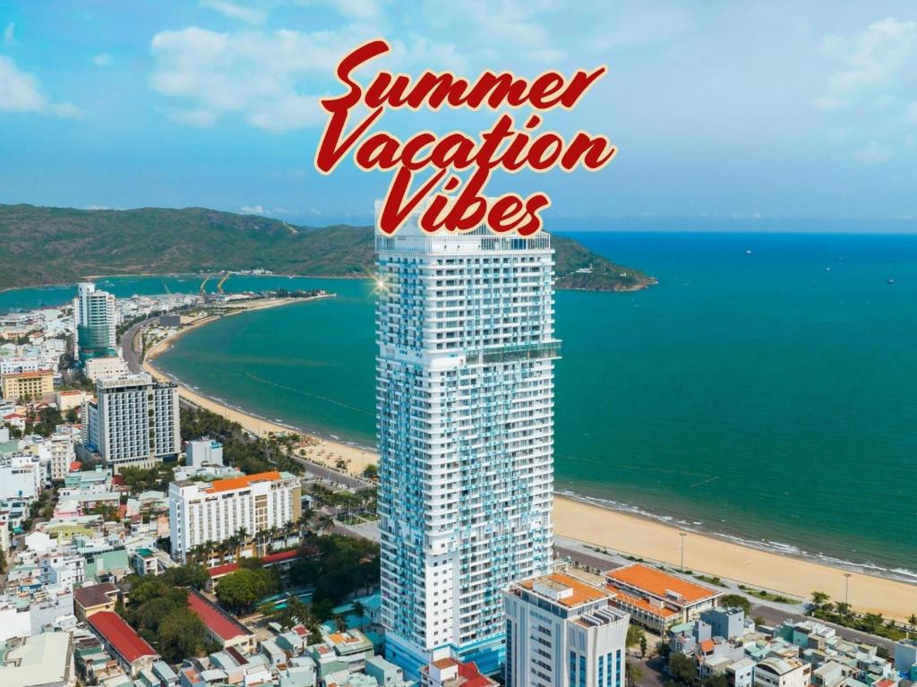 a tall building next to the beach with the words summer vacation villages at TMS Beachfront Quy Nhon Apartment in Quy Nhon