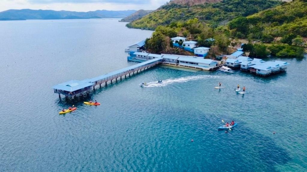 an aerial view of people in the water at a resort at Coron Underwater Garden Resort in Coron