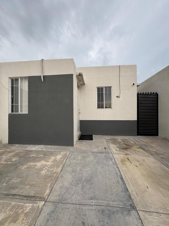 a building with a large door on the side of it at Equipped house in Salinas industrial zone in Ciudad Satelite del Norte