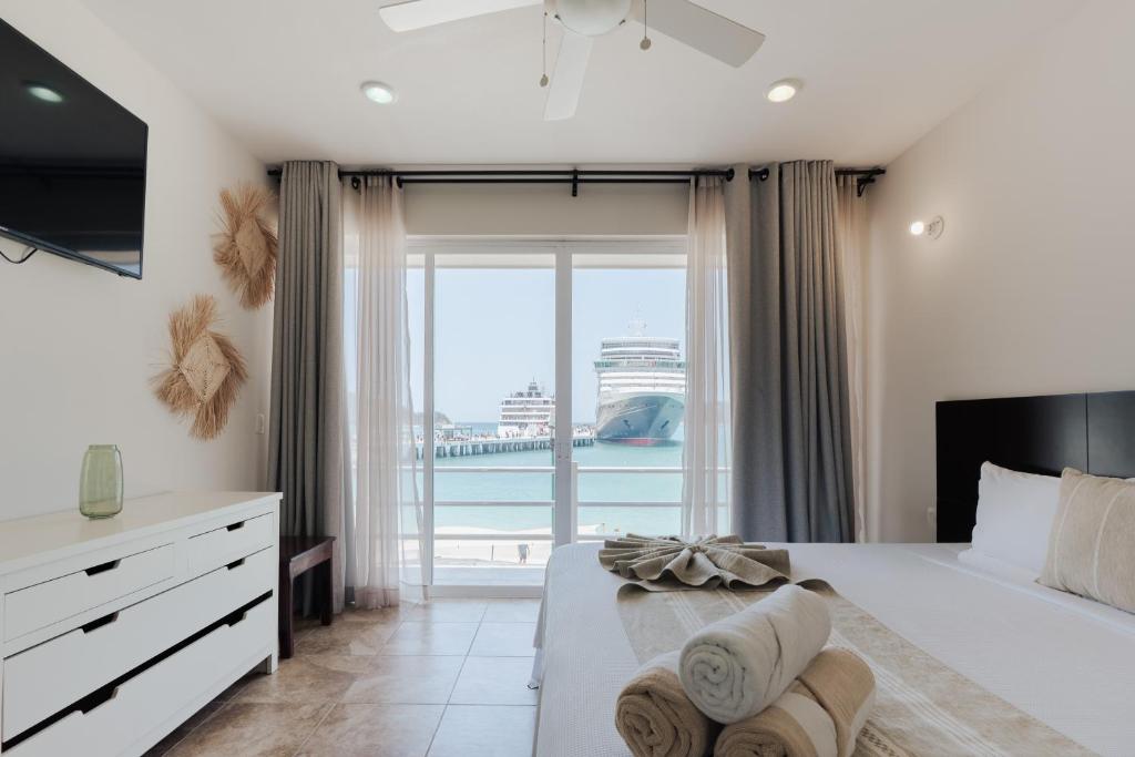 a bedroom with a large bed with a view of the ocean at Suites La Playa in Santa Cruz Huatulco