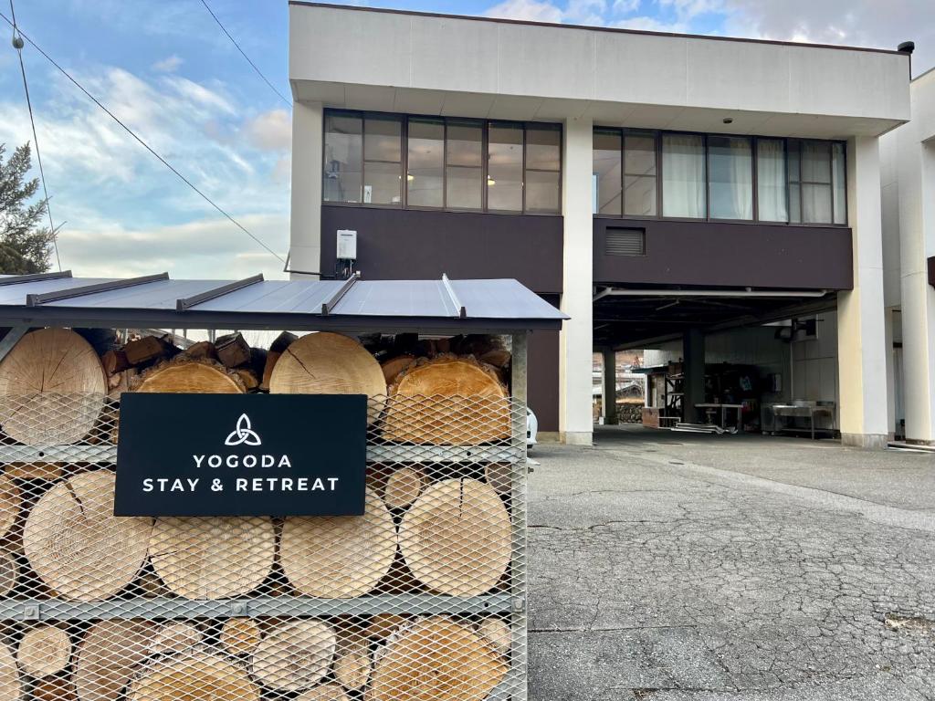 a building with a bunch of hay and retrieval signs at ヨゴダステイアンドリトリート Yogoda Stay & Retreat in Ina