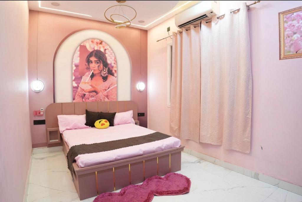 a bedroom with a bed with a painting on the wall at The White Lilly in Noida