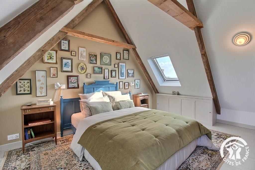 a bedroom with a large bed in a attic at Clos des sentiles in Perros-Guirec