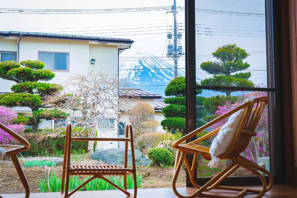 two chairs sitting in front of a window at WTN Way too nice in Fujikawaguchiko