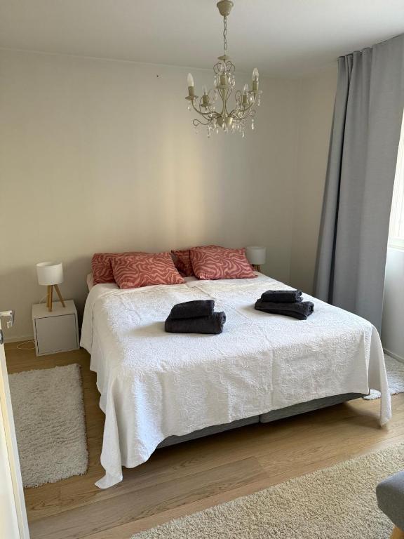 a bedroom with a bed with two black towels on it at Paimenkatu 1 in Savonlinna