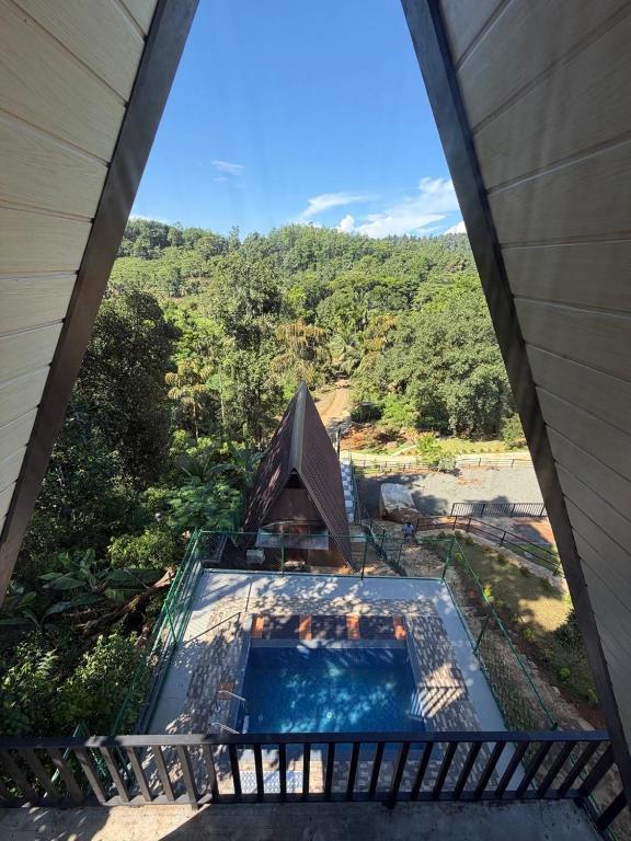 an overhead view of a house with a swimming pool at Sinharaja Kithula Eco Cabanas in Batuwangala