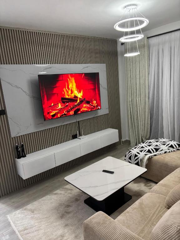 a living room with a fire on the wall at Apartment in Kitusuri in Nairobi