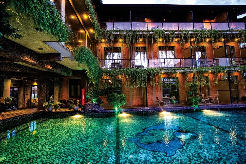 a swimming pool in the middle of a building at Arama Transit Hotel in Katunayaka