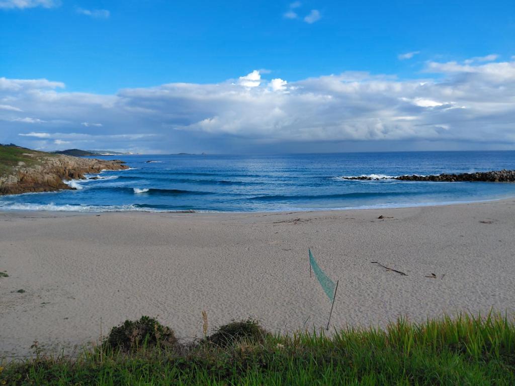 a sandy beach with the ocean in the background at Villa Laxes in Burela de Cabo