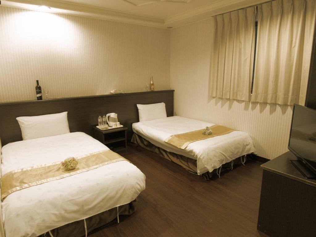 Postel nebo postele na pokoji v ubytování Yi Pin Yuan Hotel