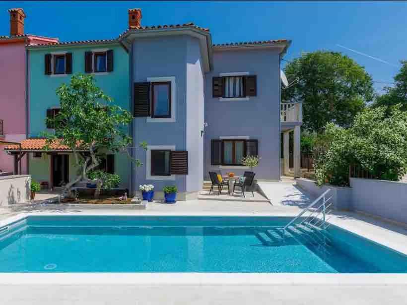 a villa with a swimming pool in front of a house at Villa Maria in Krnica