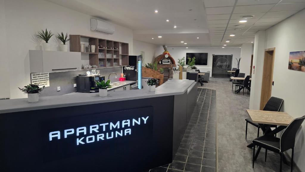 an office lobby with a pharmacy kronium sign on a counter at Apartmány Koruna in Ostrava