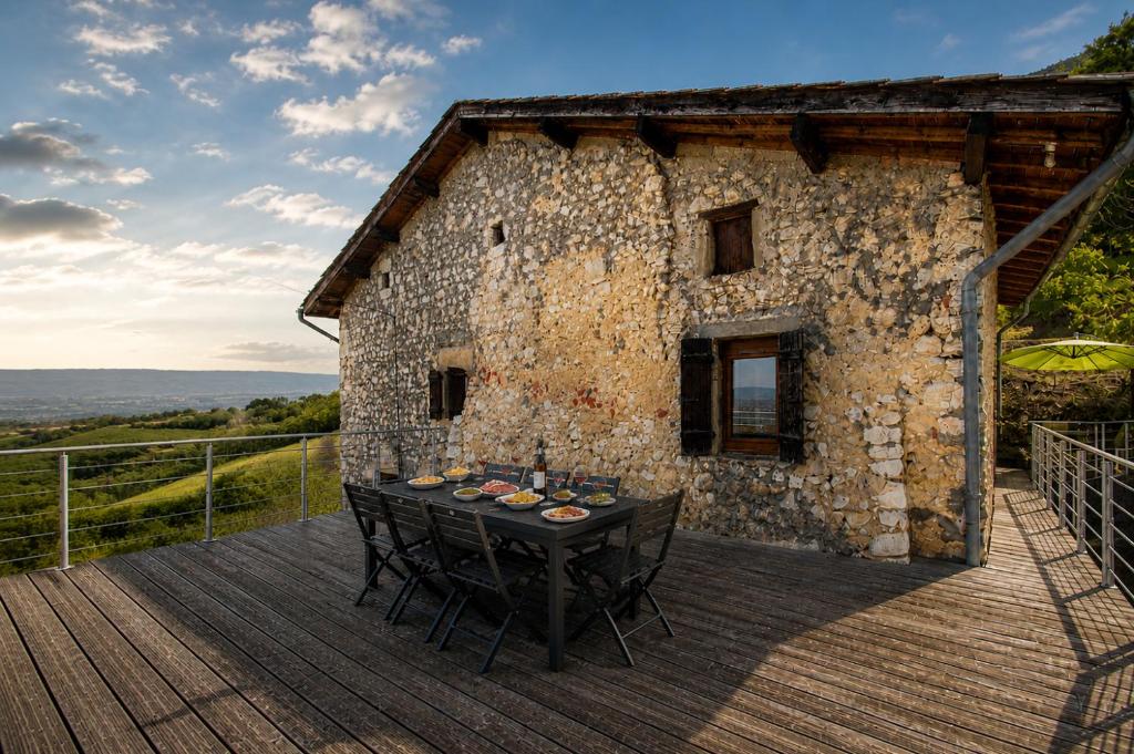 a table on the deck of a stone building at L'évasion authentique du Vercors in Saint-André-en-Royans