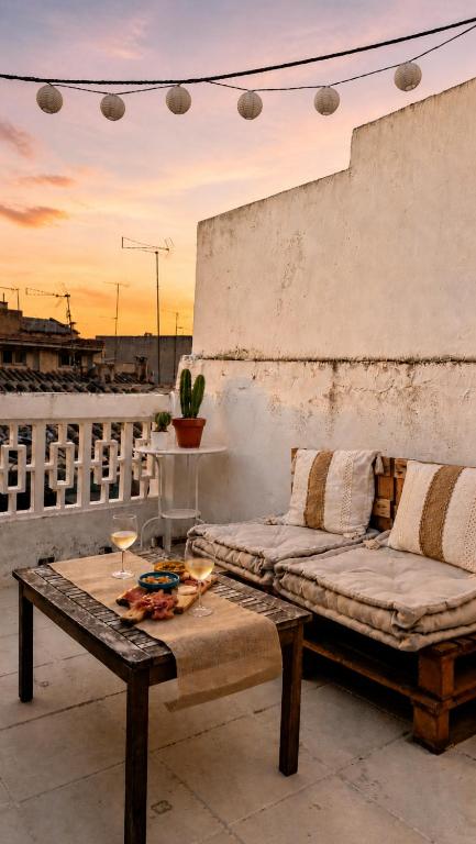 a couch and a table on a balcony at La Casita Vertical casco histórico de Segorbe in Segorbe
