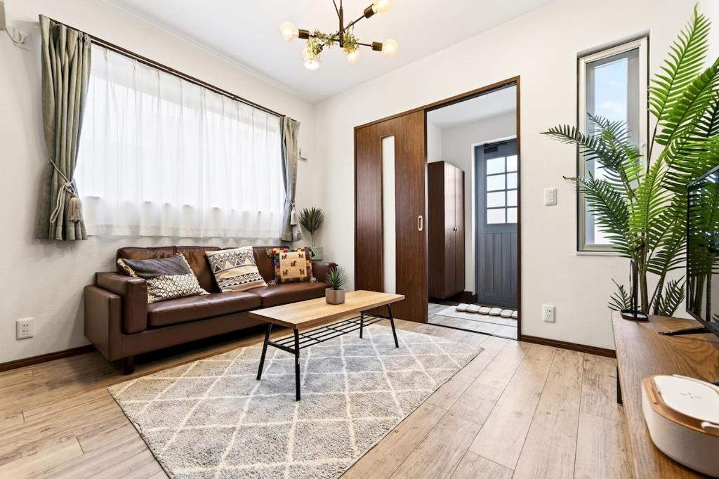 a living room with a couch and a table at Value residence Kugai 3A in Miyako-jima