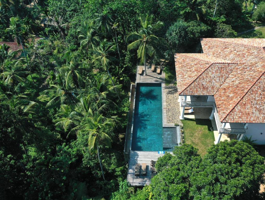 an aerial view of a house with a swimming pool at Good Vibes Villas in Unawatuna
