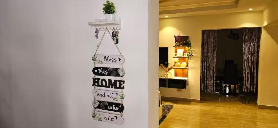 a living room with a sign on the wall at The Blessing Villa Vellore in Vellore