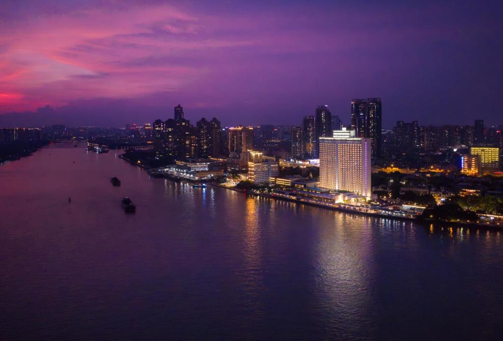 a view of a city at night with a river at White Swan Hotel in Guangzhou