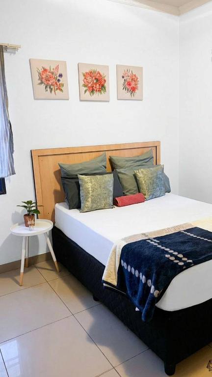 a bedroom with a large bed with at Zak Guest House in Manzini