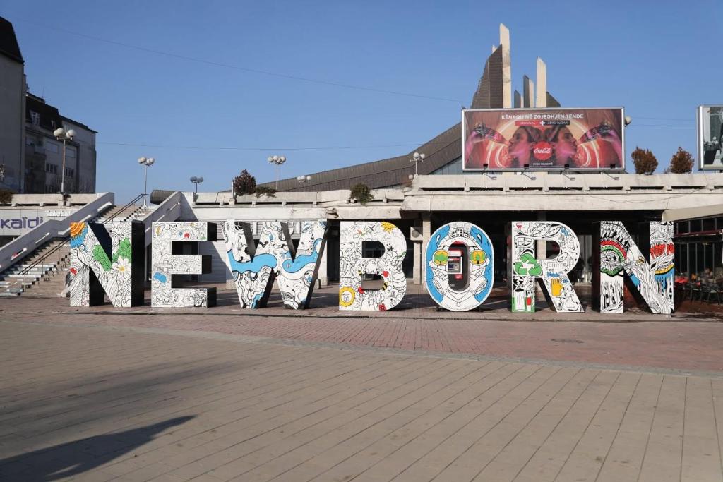 a sign that says newport on the side of a building at Boulevard Studios NewBorn in Prishtinë