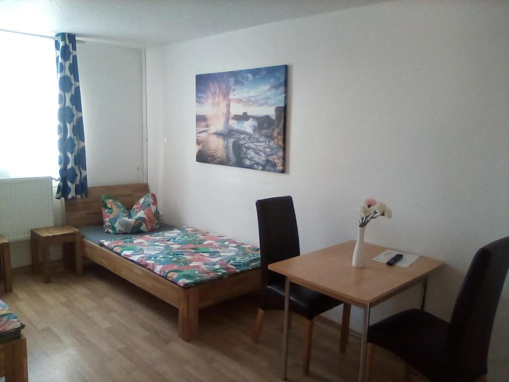 a room with a table and a couch and a table and a table at Monteurzimmer Ehmen in Wolfsburg