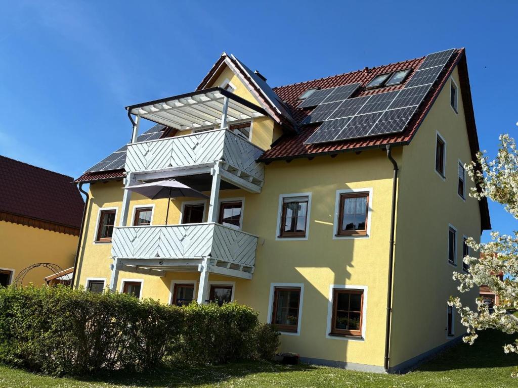 a house with solar panels on its roof at Pension-Gästehaus Küblböck in Neualbenreuth