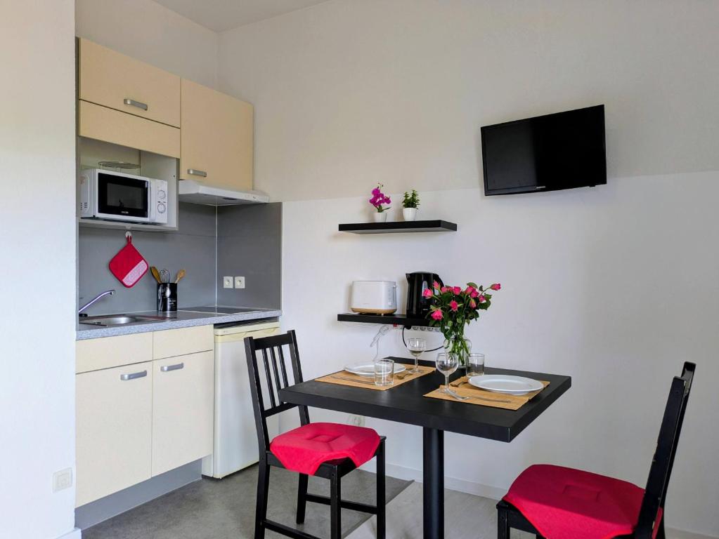 a small kitchen with a table and two chairs at Virginia N101 ST2 in Grasse
