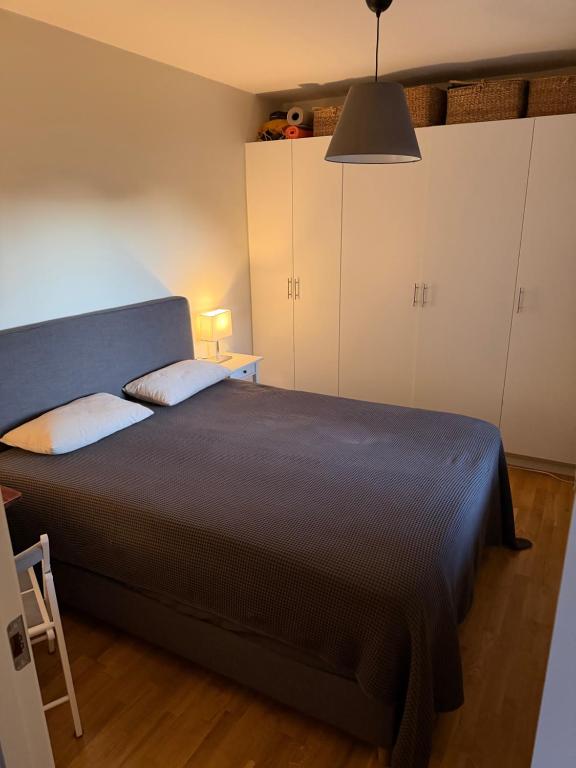 a bedroom with a large bed and a table and cabinets at PRIVATE ROOM in a shared apartment in Västerås