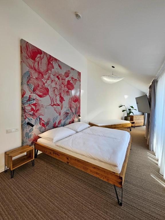 a bedroom with a bed with a painting on the wall at Hotel U Feldů in Klimkovice