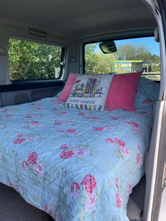 a bed in the back of a van at Allys cute Campervan in Carbis Bay