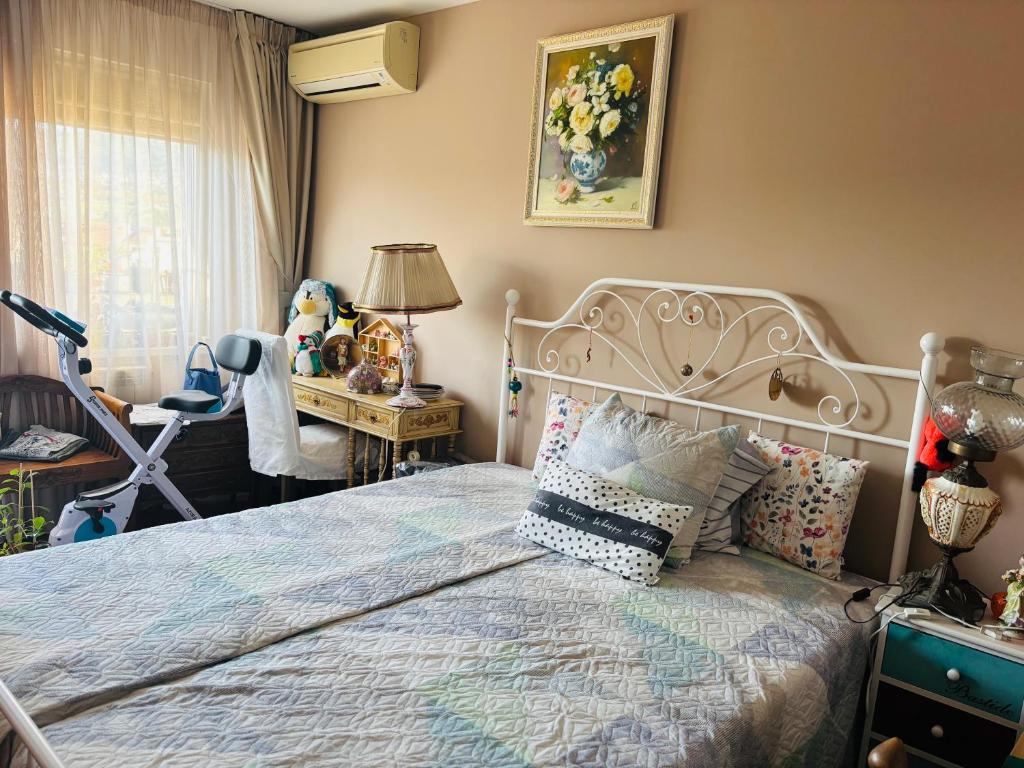 a bedroom with a bed and a desk and a window at Experience at Malinova dolina in Sofia