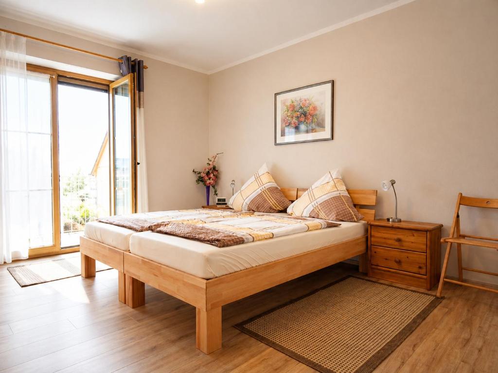 a bedroom with a large bed and a window at Ferienwohnungen Stark in Kelheim