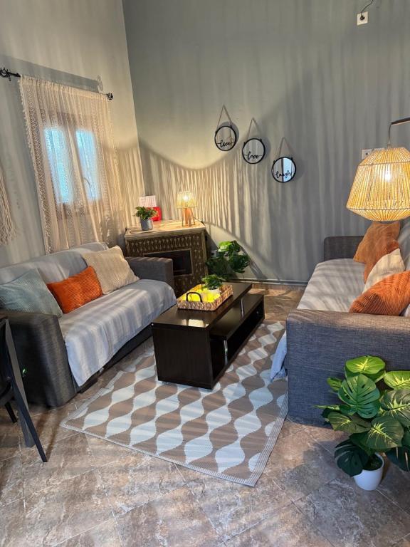 a living room with a couch and a coffee table at Aliki's house in Líthion