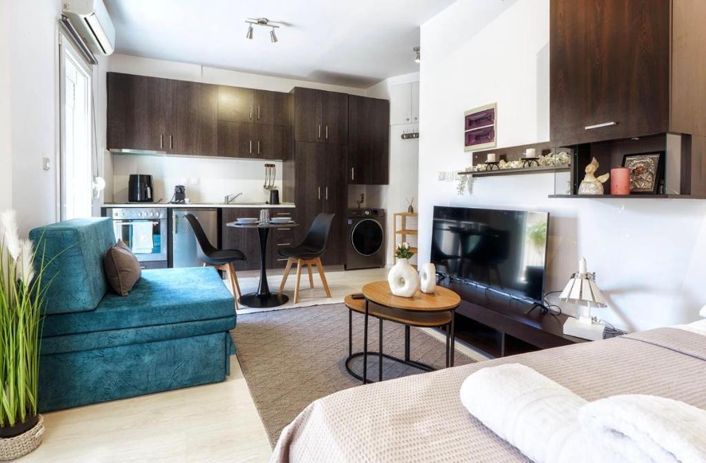 a room with a bed and a living room and a kitchen at Elysian Hightower in Thessaloniki