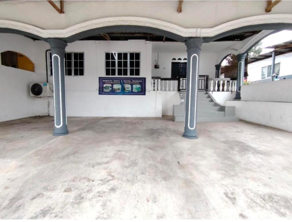 a large empty room with columns and a staircase at Homestay Bakti in Bandar  Pusat Jengka