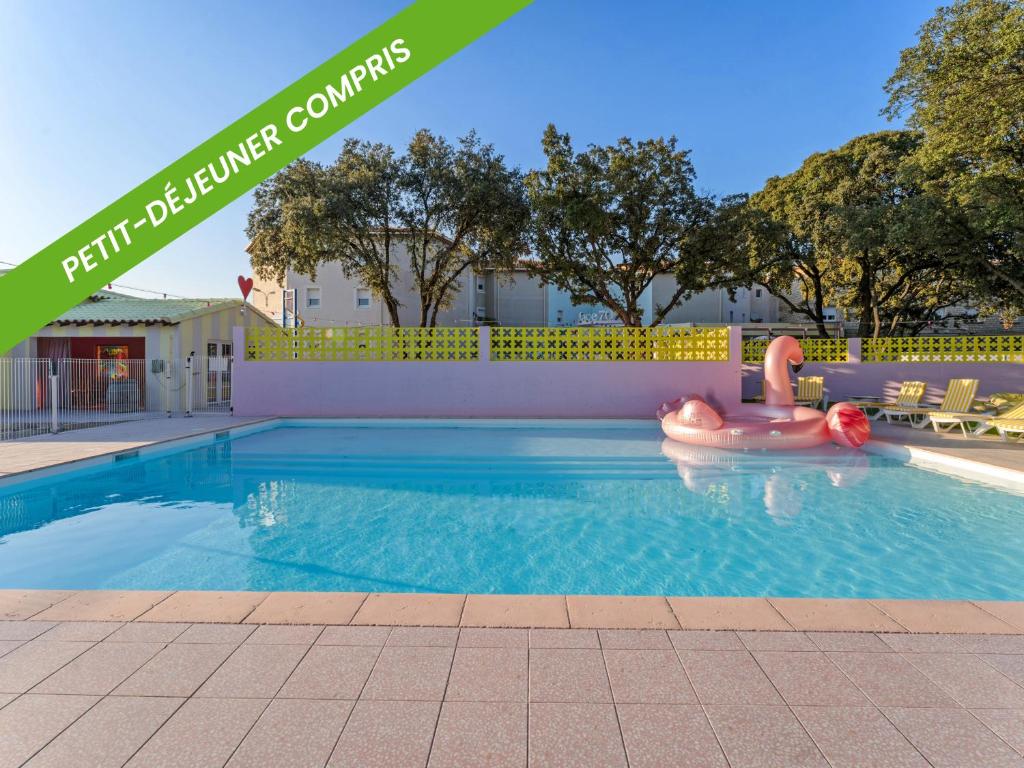 a swimming pool with an inflatable raft in the middle at ibis Styles Pont du Gard Route d'Avignon in Estézargues