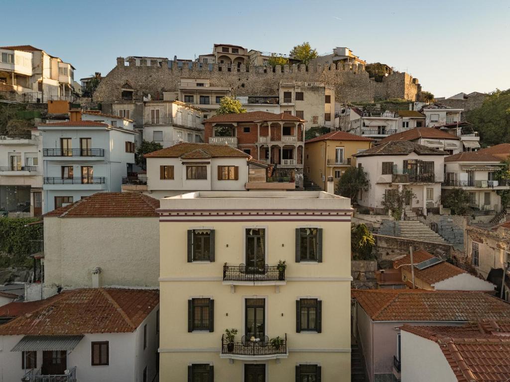 a white building in the middle of a city at Oikia Classic House in Old Town Kavala in Kavála