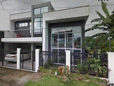 a house with a car parked in front of it at Rosa Executive Residence in heart of Ormoc City in Ormoc
