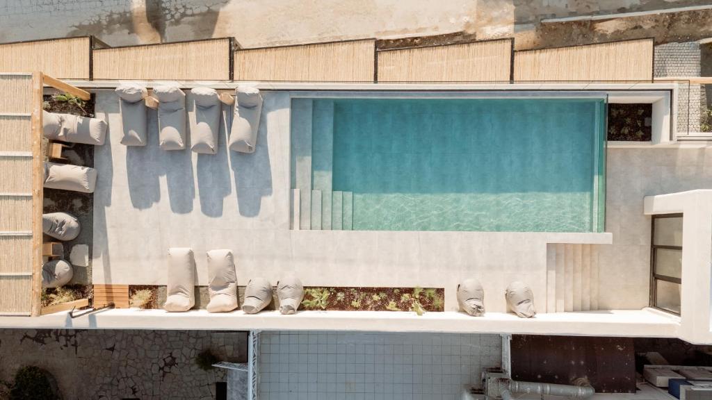 a building with a swimming pool with white shoes on it at MINT Keramoti in Keramoti