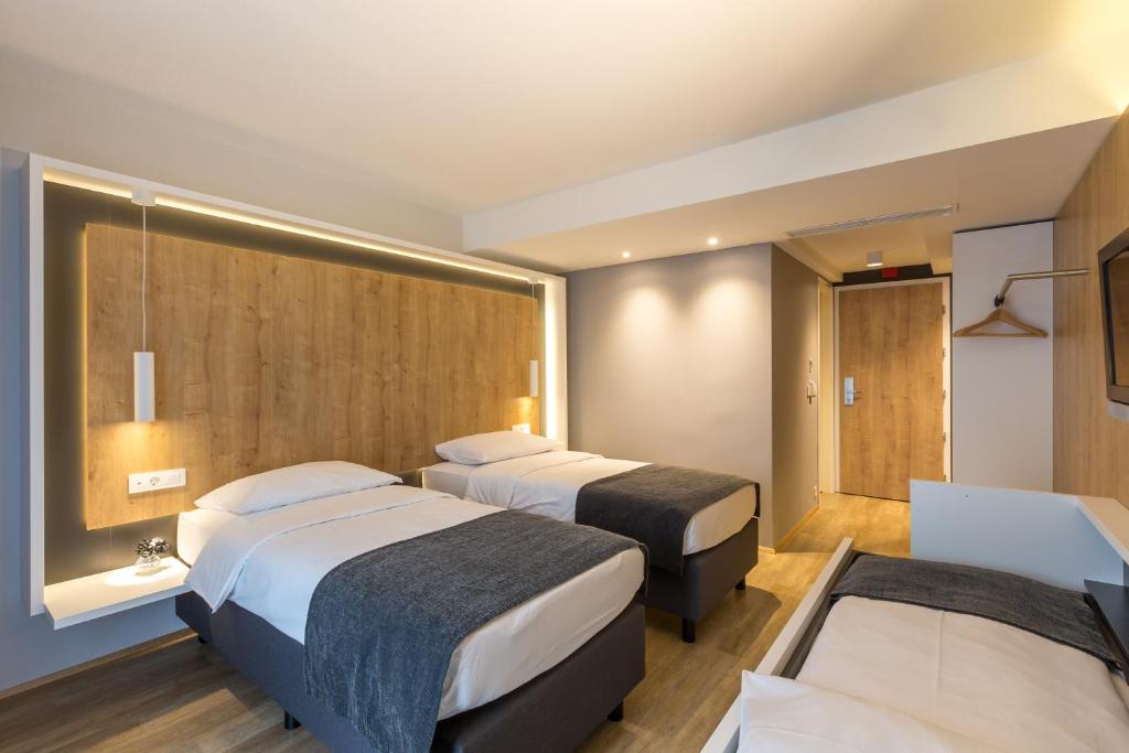 Postelja oz. postelje v sobi nastanitve M Hotel