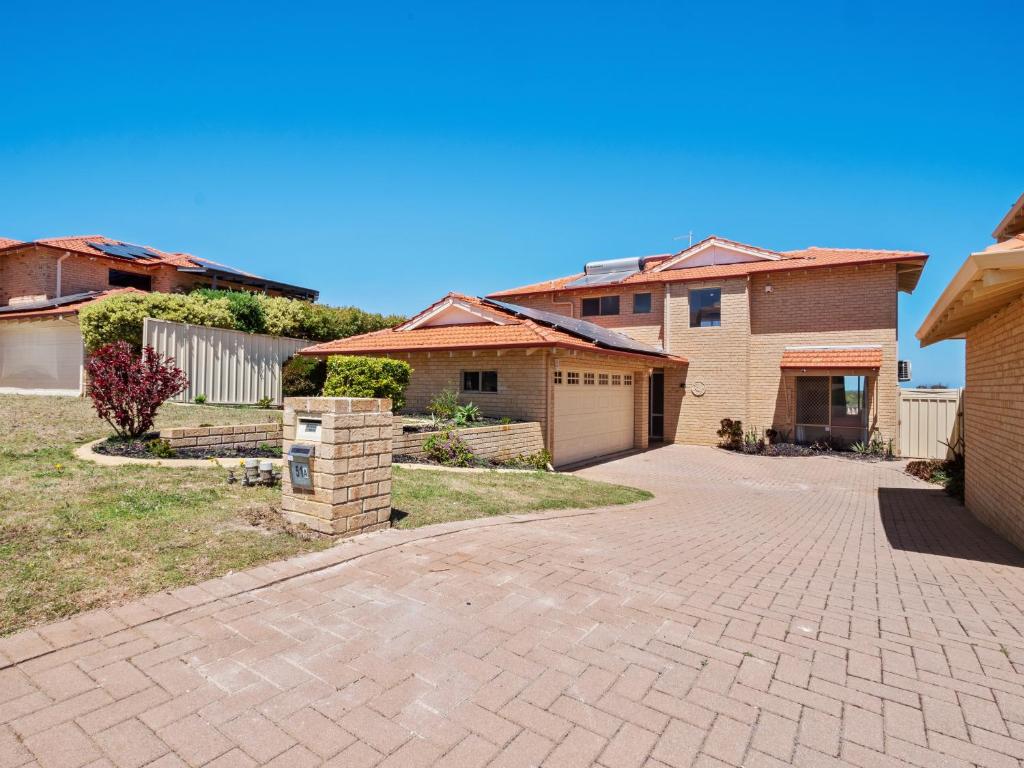 a brick driveway in a yard with houses at Ocean Reef Marina by the Sea 4BR plus Study plus in Perth