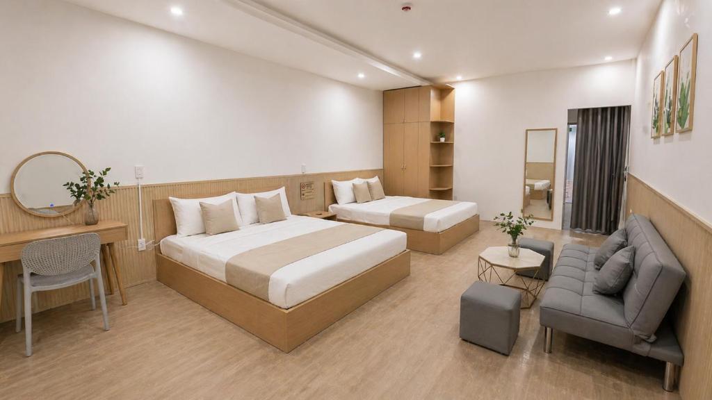 a hotel room with a bed and a desk at Lemon Hotel & Apartment in Danang