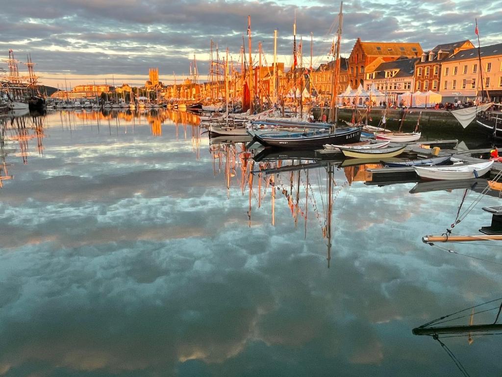 a group of boats are docked in a harbor at Les ducs de Normandie in Fécamp