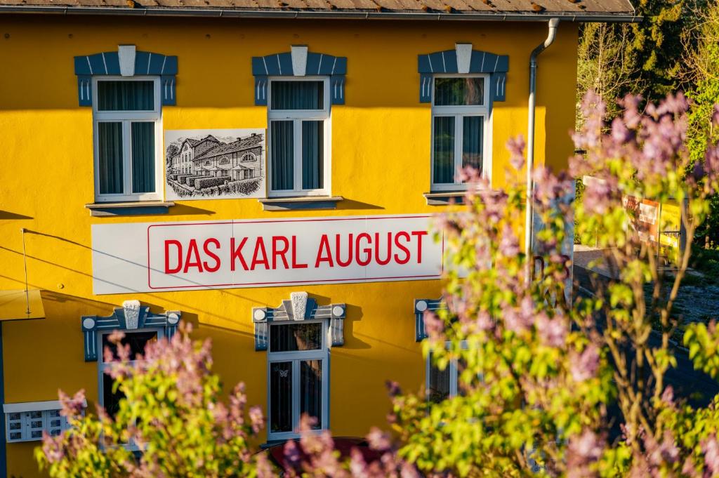 a yellow building with a sign that reads dass karma adjust at Das Karl August in Fohnsdorf