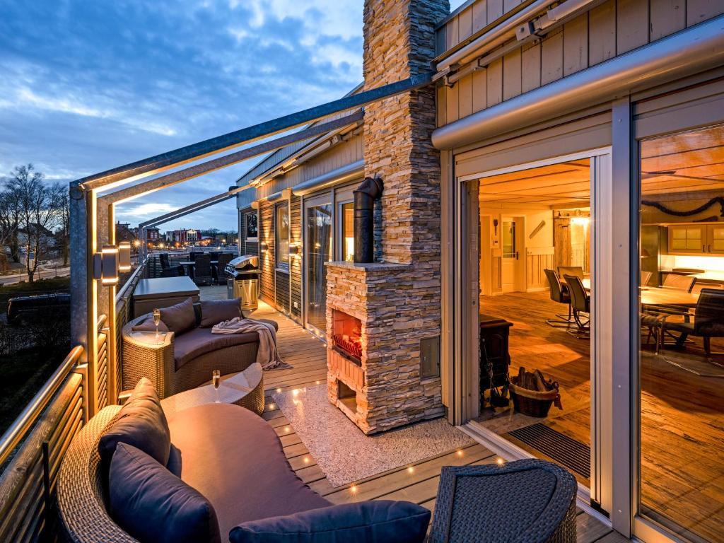 a patio with couches and a fireplace on a house at Admiral Stuuv in Barth