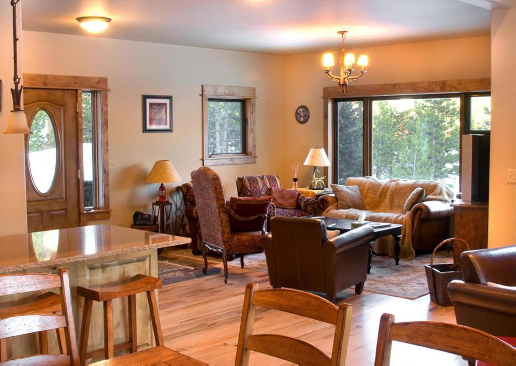 a living room filled with furniture and a table at Twin Lift Lodge in Big Sky Mountain Village