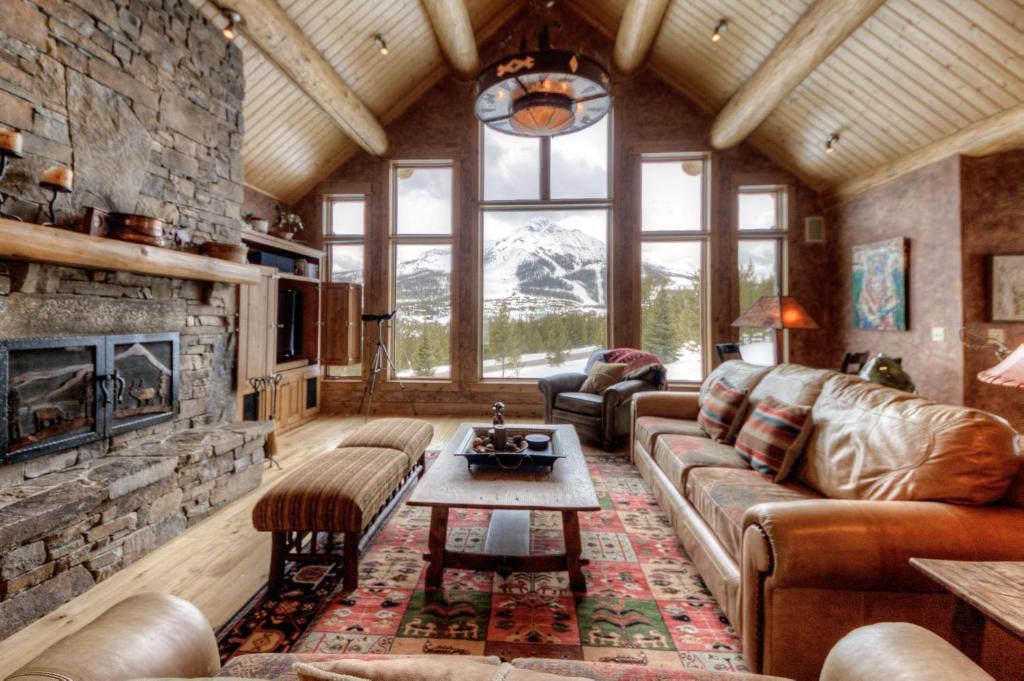 a living room with a couch and a fireplace at Lone View Lodge in Big Sky Mountain Village